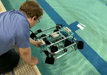Setting the ROV down from the pool deck
